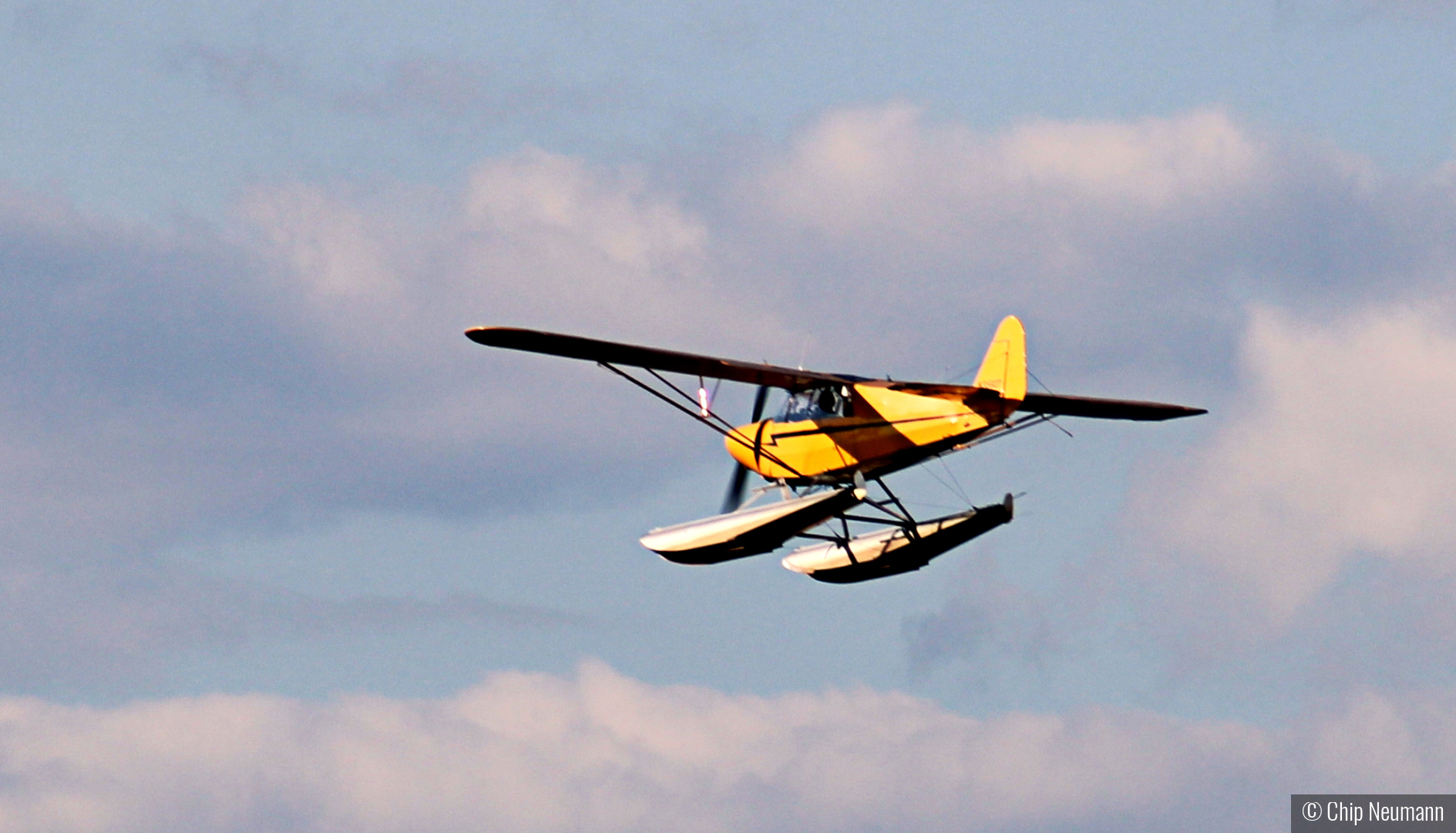 Float plane after takeoff by Chip Neumann