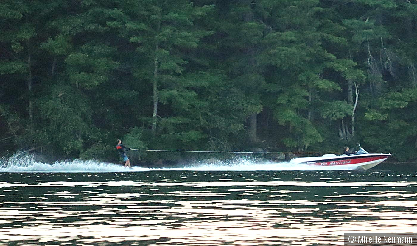 Water skier on a calm lake by Mireille Neumann